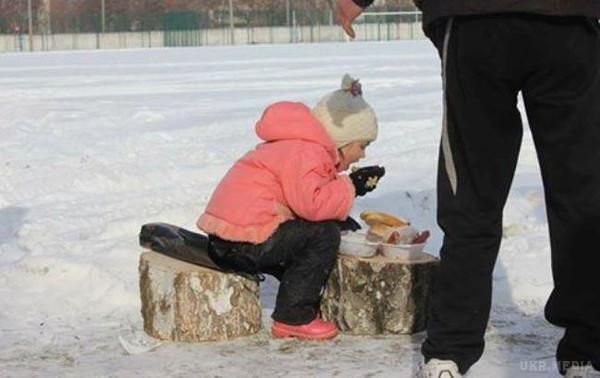 "Росіянам дивитися сюди". У мережі показали фото дівчинки з Авдіївки. У мережі показали фотографію маленької дівчинки з Авдіївки, яка в мороз їсть на вулиці, сидячи на пеньку.