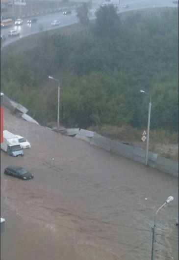 У Росії потоп перетворив вулиці міста в вируючі річки (фото, відео). На кадрах помітно людей по пояс у воді і машини, затоплені практично по дах.