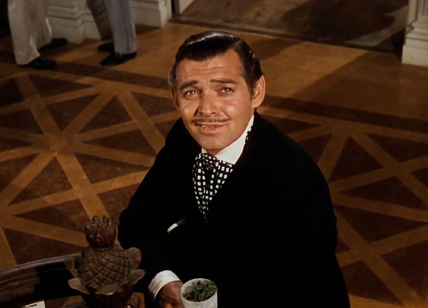 Кларк Гейбл у ролі Ретта Батлера, актор фільму 'Віднесені вітром' і Король Голлівуду, чия доля описується в статті.